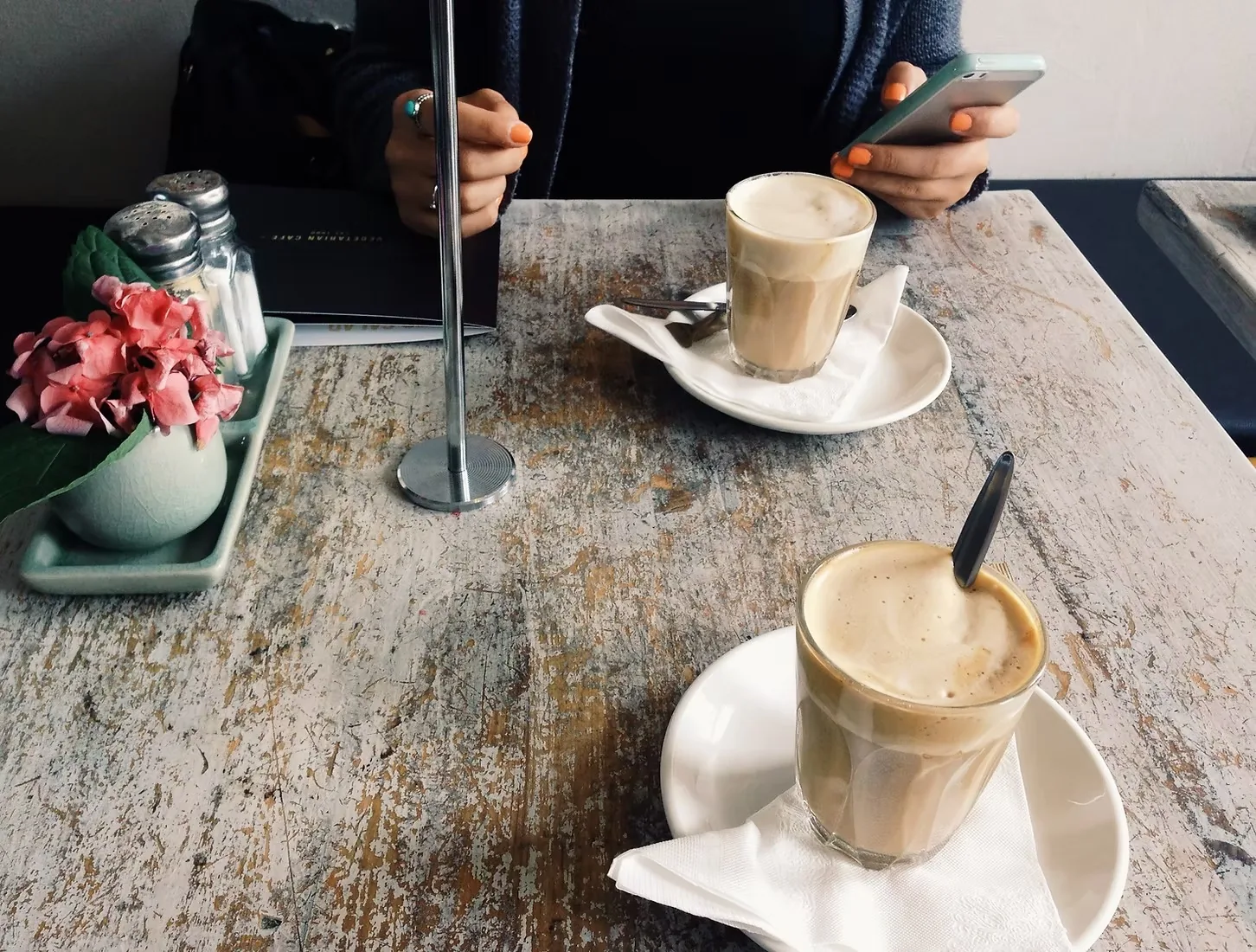 Two lattes on a café table at Soho on Miller